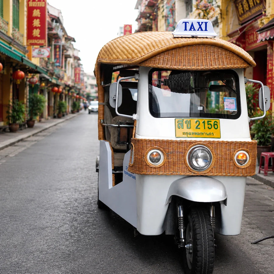 Classic tuk tuk on a colourful Yaowarat shophouse street in Bangkok Chinatown