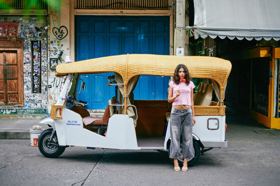 TUK ME electric tuk tuk parked outside a street-art doorway in Talat Noi, Bangkok