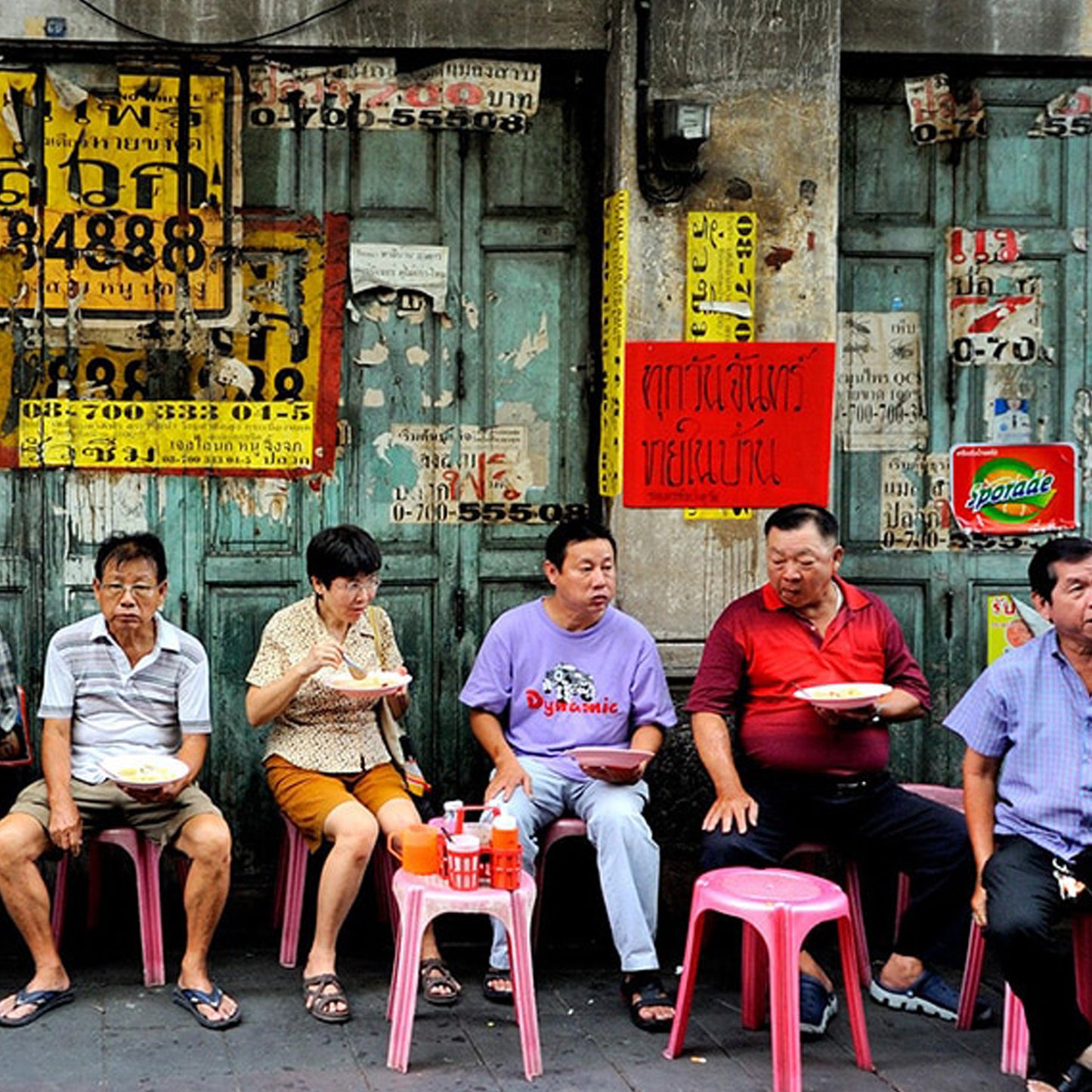 Locals enjoying street food in Bangkok Chinatown, authentic food experiences with TukMe Tuk Tuk tours