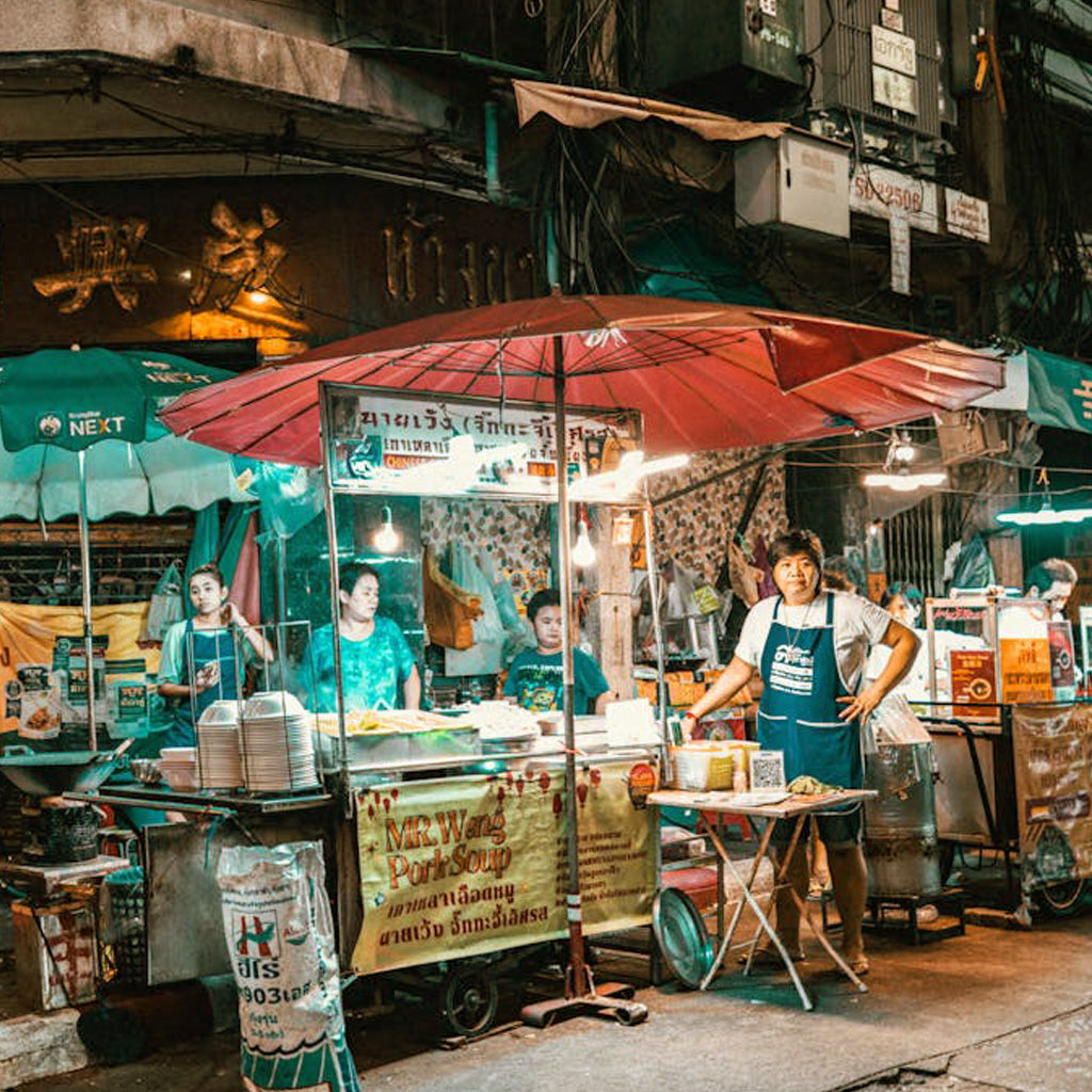 Street vendor selling pork soup in Bangkok Chinatown, authentic local flavors with TukMe Tuk Tuk tours