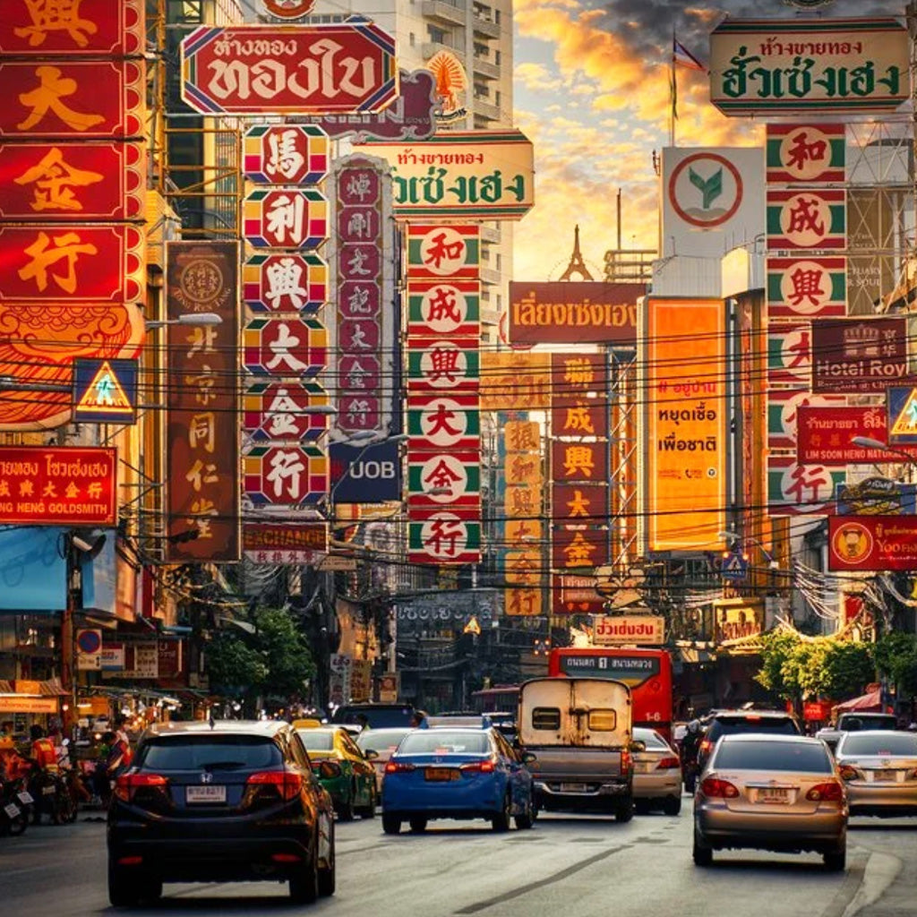Colorful neon and shop signs on Yaowarat Road in Bangkok Chinatown, explore vibrant streets with TukMe Tuk Tuk tours