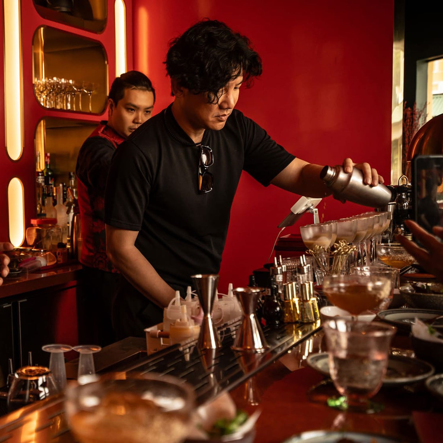Professional mixologist crafting cocktails at Bangkok speakeasy bar during TukMe tuk tuk bar hopping tour
