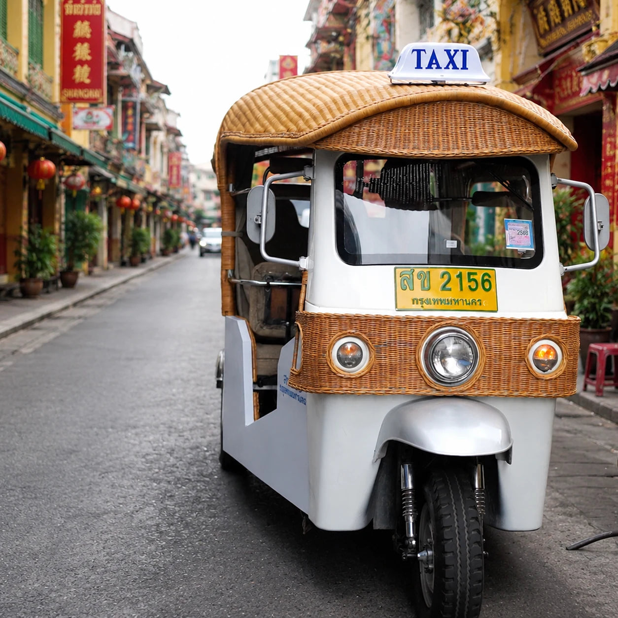 Classic white tuk tuk on a colourful Yaowarat shophouse street in Bangkok Chinatown — TUK ME tours
