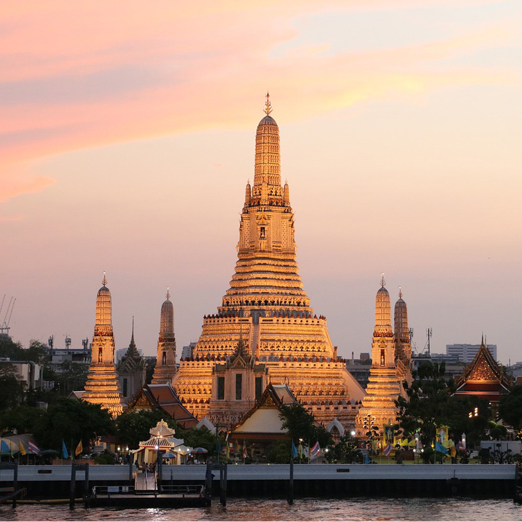 Wat Arun temple at sunset in Bangkok, view iconic riverside sites with TukMe Tuk Tuk tours